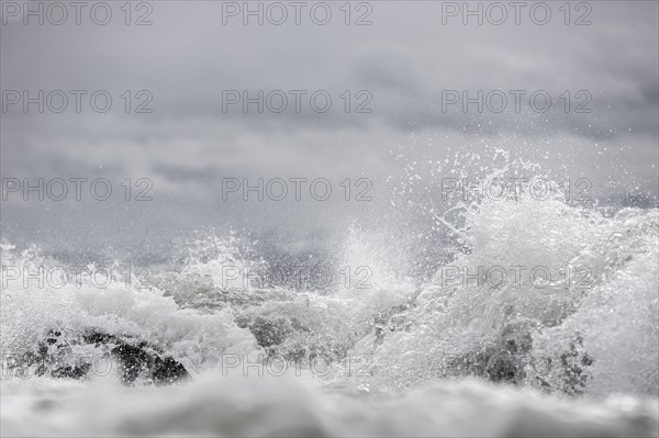 Storm Lolita raging on the rocky shore with waves in Hagnau