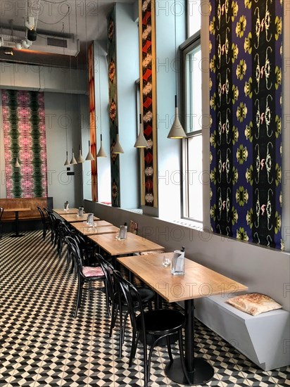 Modern furnished restaurant with different colourful patterned wallpapers
