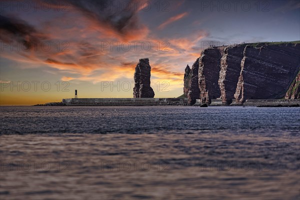 View from the sea to the rocky island of Helgoland with surf pillar Lange Anna