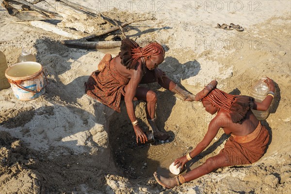 Himba women collecting water at a water hole