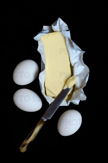 Butter in opened packaging and eggs