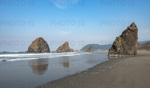 Sandy beach beach with sea and big rocks