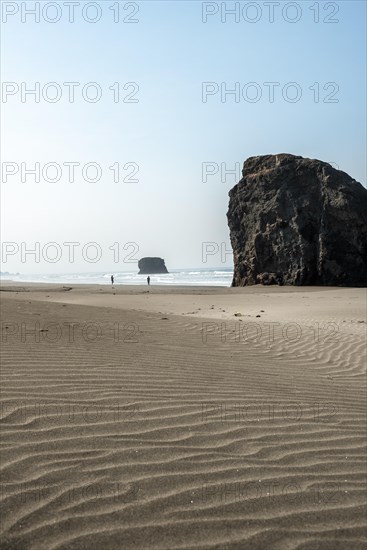 Sandy beach beach with sea and big rocks