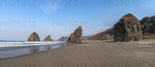 Sandy beach beach with sea and big rocks