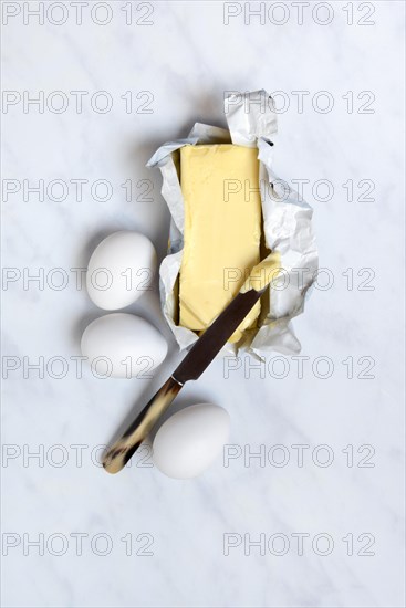 Butter in opened packaging and eggs