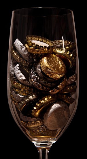 Crown caps collected in a beer glass