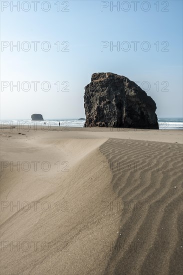 Sandy beach beach with sea and big rocks