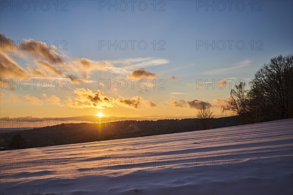 Sunset over a field covered with snow near Wiesent