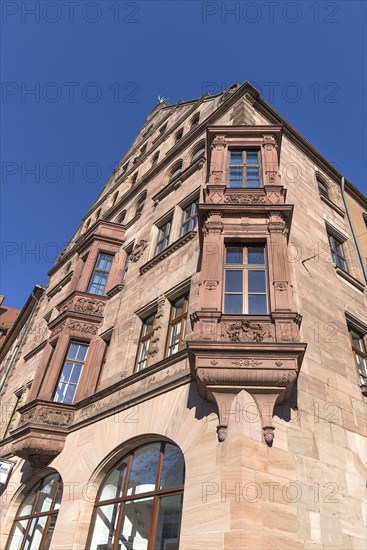 Residential and commercial building with double bay window in neo-Renaissance style