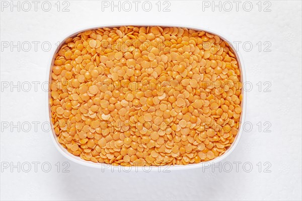 The red split lentil also known as Egyptian lentil or Masoor dal against white background