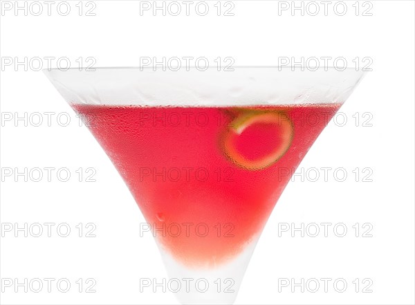 Cosmopolitan drink cocktail straight up on martini cup with lime peel isolated on white background