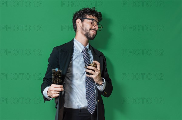 Elegant businessman perfuming himself and combing his hair