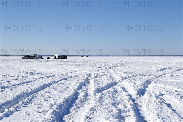 Tire tracks in snow on a frozen river