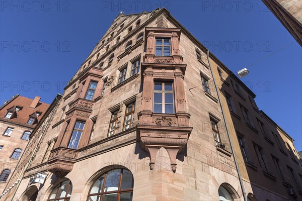 Residential and commercial building with double bay window in neo-Renaissance style