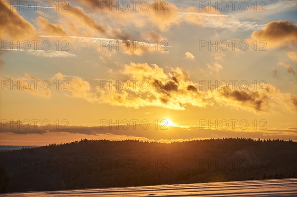 Sunset over a field covered with snow near Wiesent
