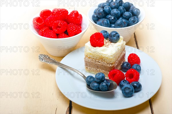 Fresh homemade raspberry and blueberry cream cake