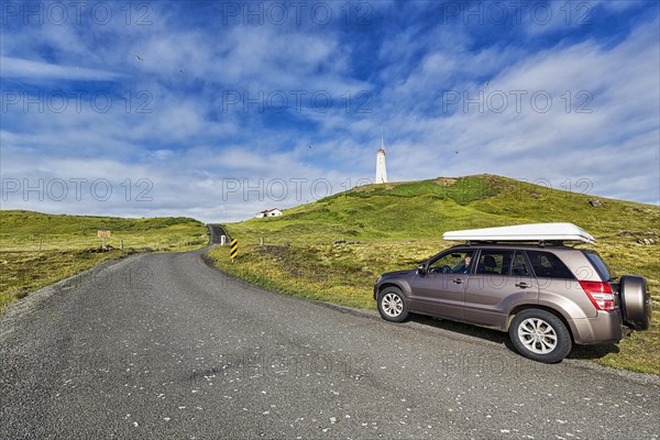 Tourist in an off-road vehicle with roof tent at the roadside