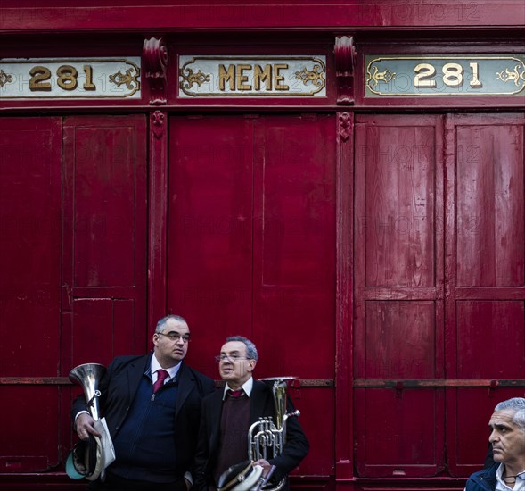 Band club members in front of an old shops facade during the National feast of St. Pauls shipwreck