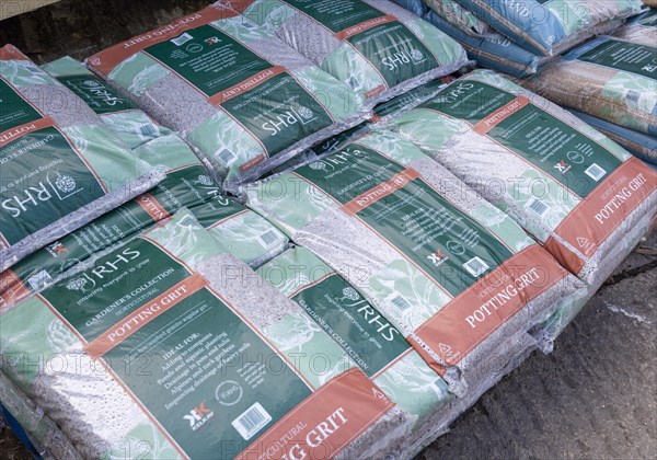 Bags of RHS potting grit piled up in garden centre