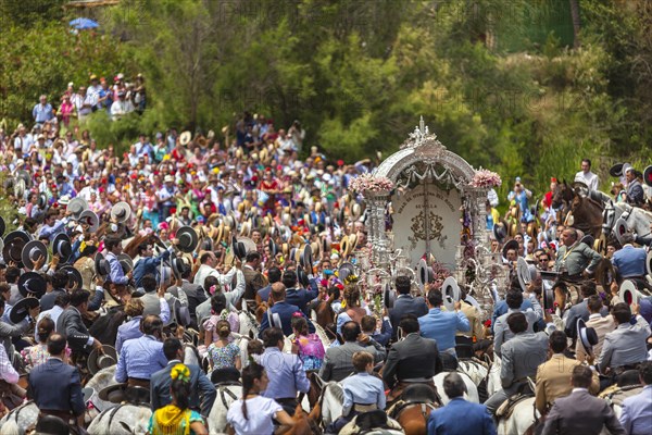 Procession with many people crossing of the river Guadalguivir