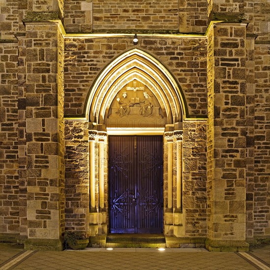 Illuminated entrance to the parish church of St. Suitbertus