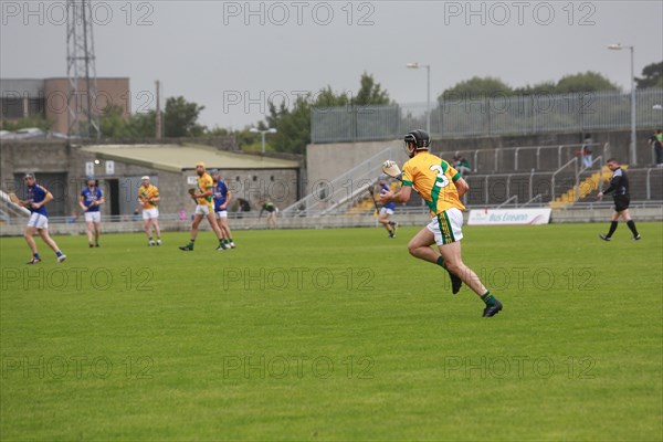 GAA player with hurley and ball during a game as Lixnaw win Kerry county hurling county final