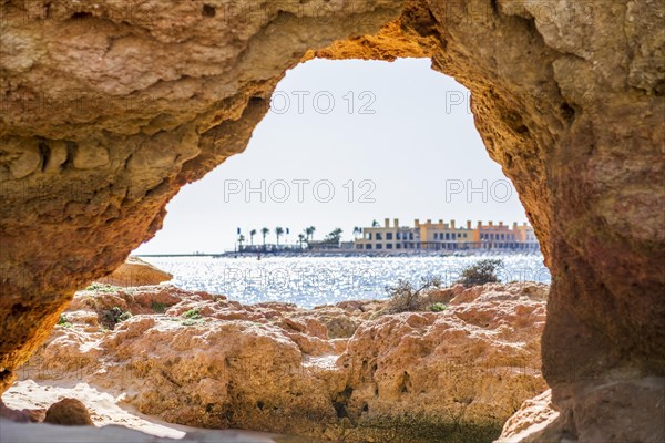 Beautiful sandstone arch with the view from Ferragudo to marina in Portimao