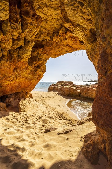 Beautiful sandstone arch with the view on marina in Portimao