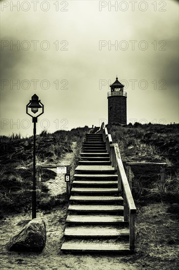 Cross light red cliff with wooden stairs