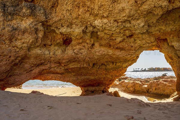 Beautiful sandstone arch with the view on marina in Portimao