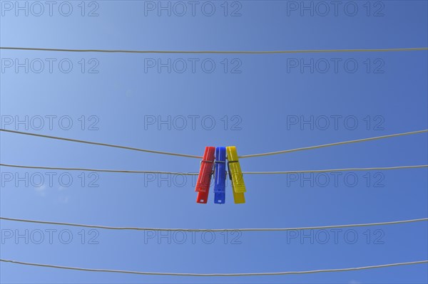 Clothesline with clothespins against blue sky