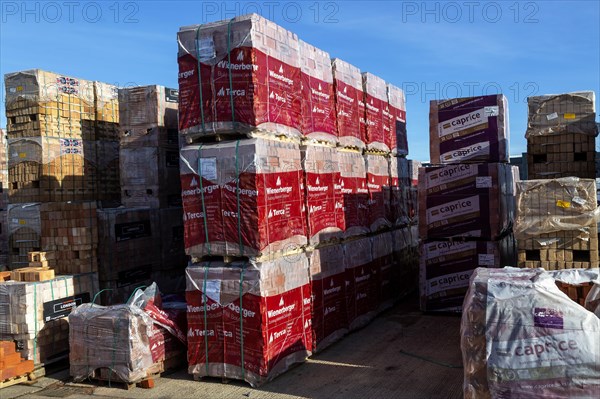 Piles of bricks in Jewson builders merchant yard