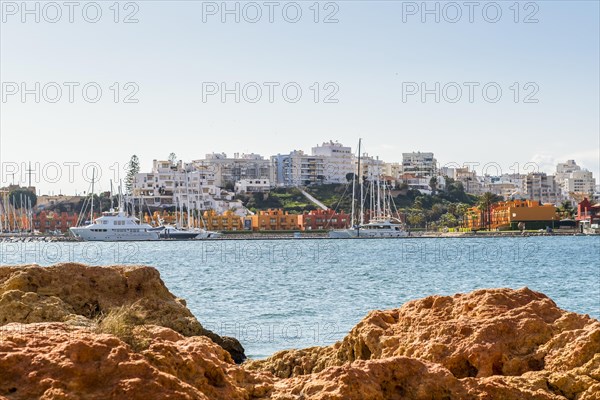 Marina in Portimao view through beautiful sandstone rocks in Ferragudo