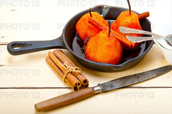 Poached pears delicious home made recipe ove white rustic wood table