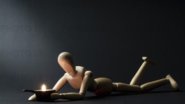 A mannequin is warmed by a fire