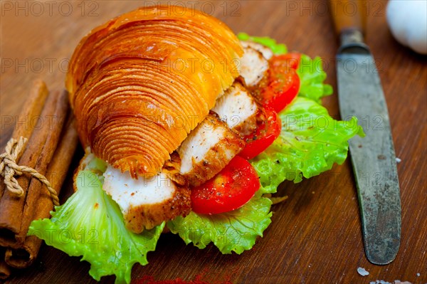 Savory croissant brioche bread with chicken breast and vegetable rustic style