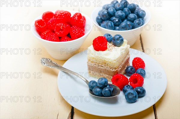 Fresh homemade raspberry and blueberry cream cake