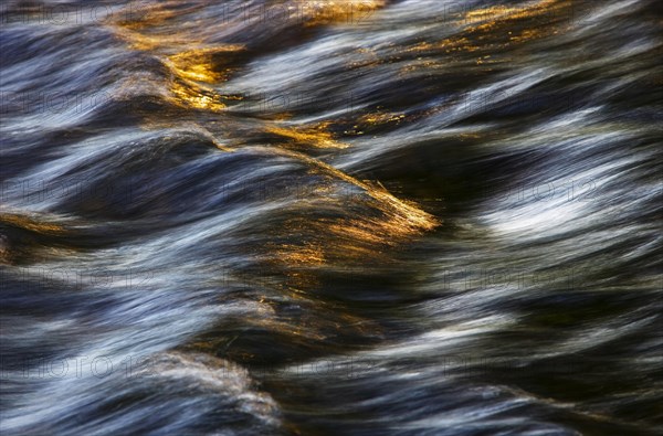 Flowing water with light reflections