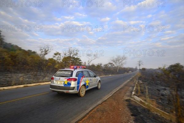 Military police vehicle on the main road 251 during a bush fire