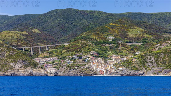 The village of Riomaggiore with its nested pastel-coloured houses built into the hillside