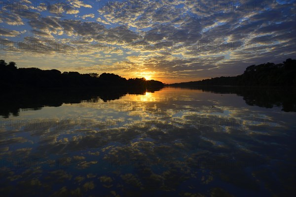 Sunrise with clouds reflected in Rio Sao Lourenco