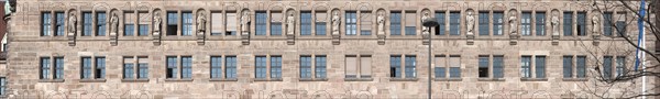 Thirteen stone sculptures of historical jurists on the main facade of the Justice Building
