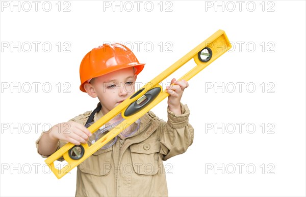 Cute young boy dressed as contractor holding level