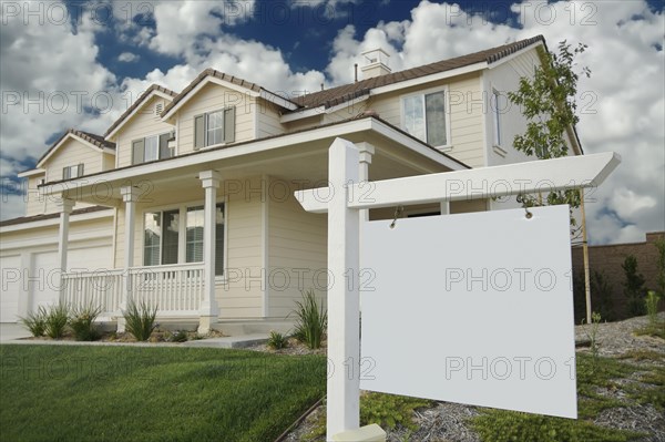 Blank real estate sign & new home ready for your own message
