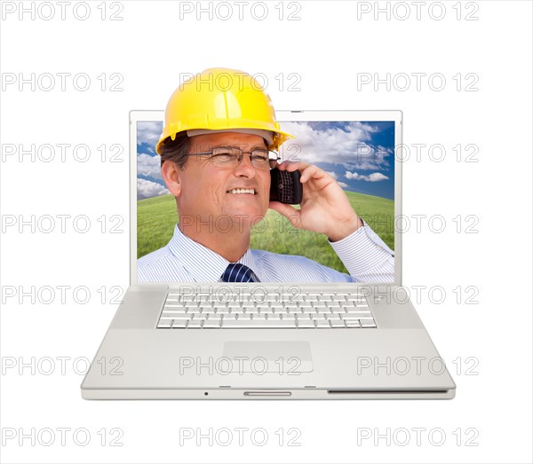 Laptop and man with hard hat on cell phone extruding the screen