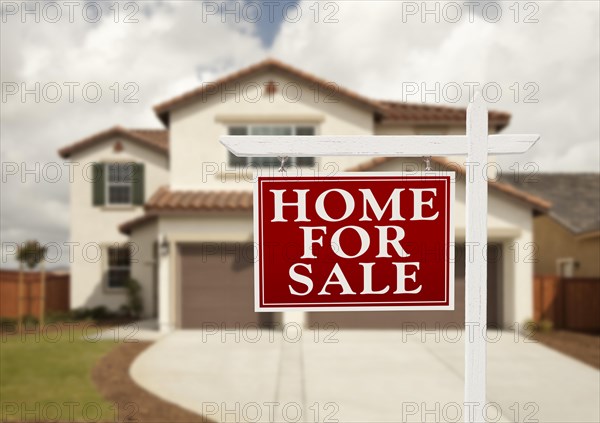 Home for sale real estate sign in front of new house