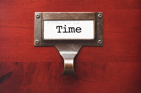 Lustrous wooden cabinet with time file label in dramatic light