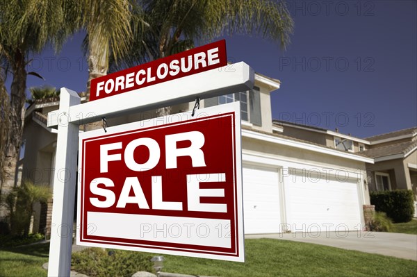 Foreclosure for sale real estate sign in front of house