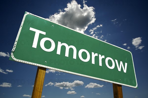 Tomorrow road sign with dramatic clouds and sky
