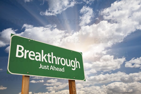 Breakthrough green road sign with dramatic clouds and sky